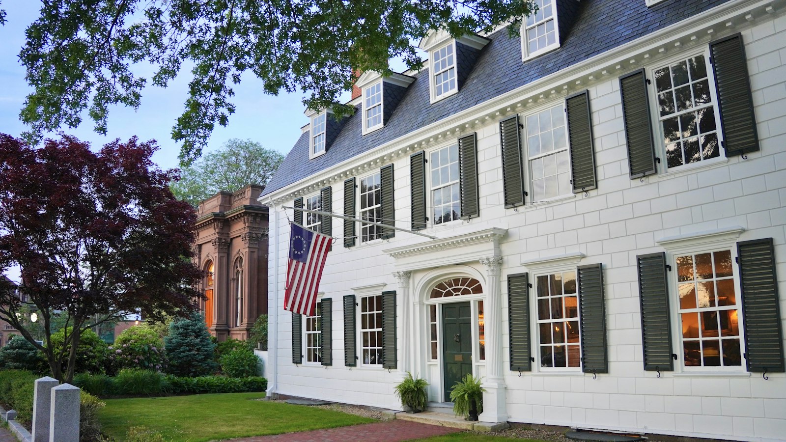 A classic New England colonial home at golden hour